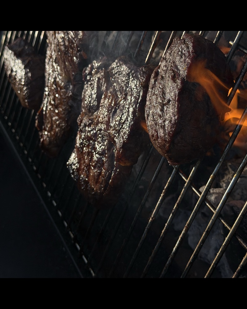 Steaks over open fire